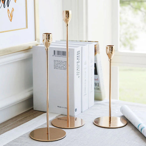 three candle holders  gold color with books